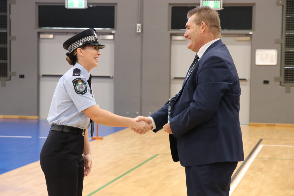 police graduate being congratulated